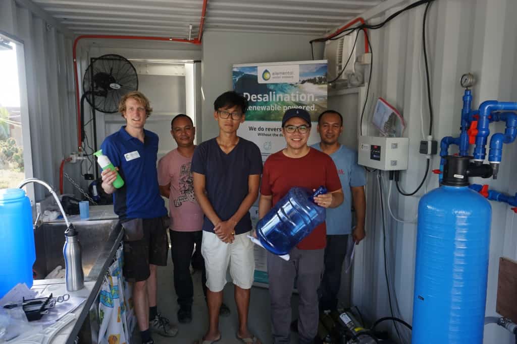 Happy local people inside the desalination container