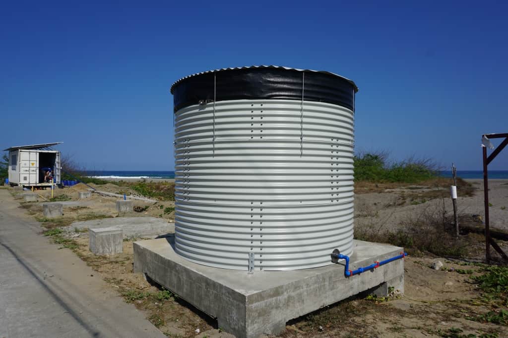 Water tank used to store the water surplus during the day, which can be used in case of water shortages during the night. It is placed next to the desalination container to keep the process local and simple. In the background there is the sea, the ultimate resource for desalinated water.