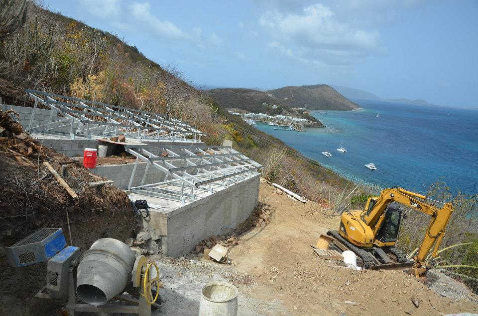 Elevated water buffer being installed on a hill on the British Virgin Islands to make the desalination process three time more efficient