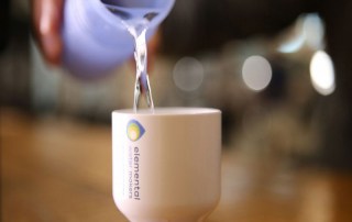 Water is neatly poured into a cup, being ready to serve the freshly desalinated water from our plug and play system to one of our customers.