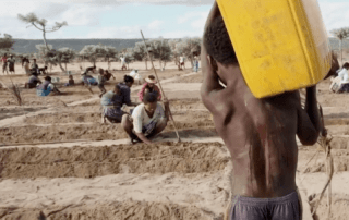 African children trying to get as much as possible from inconsistent rainfalls