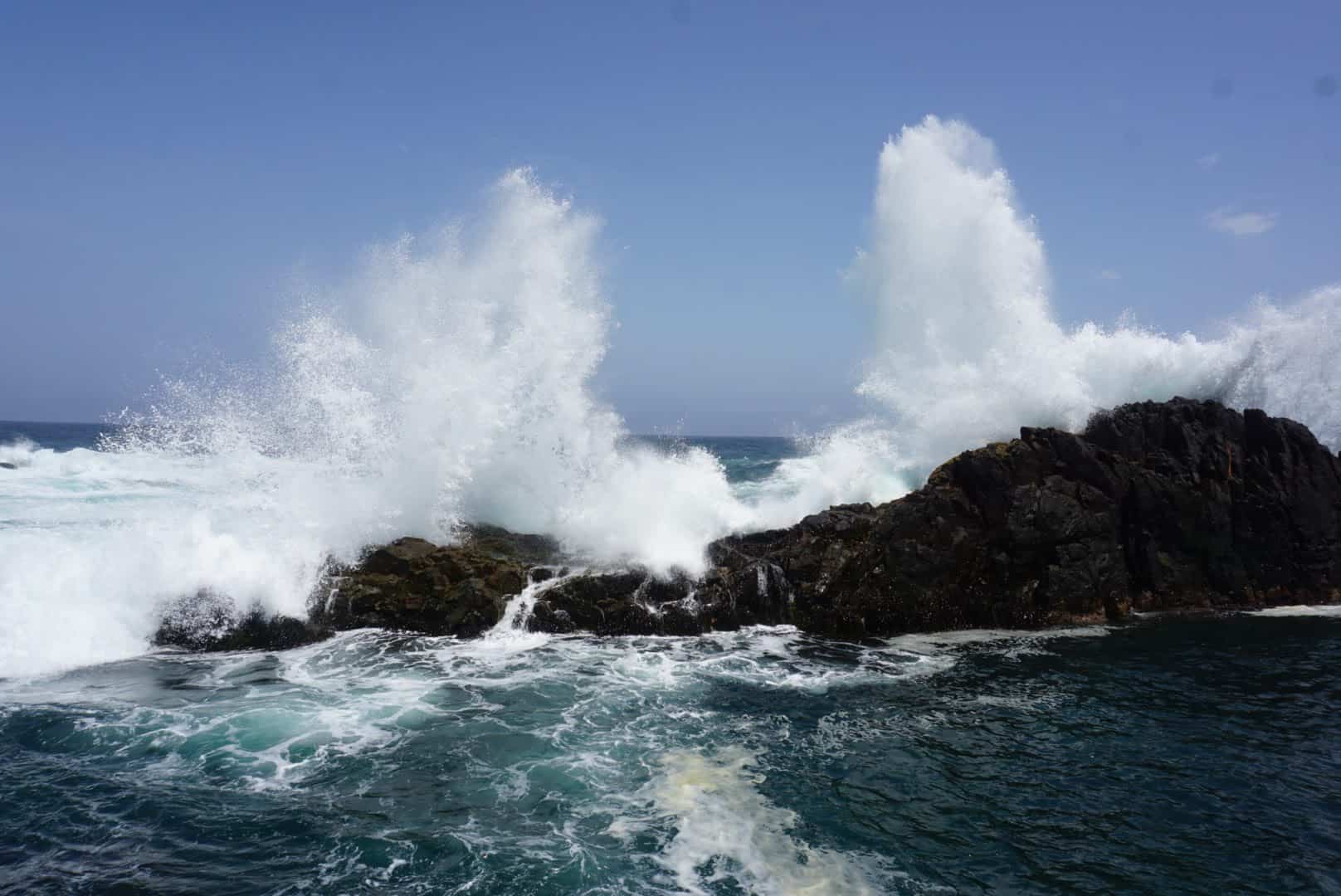 Water splashing over rocks on the shore